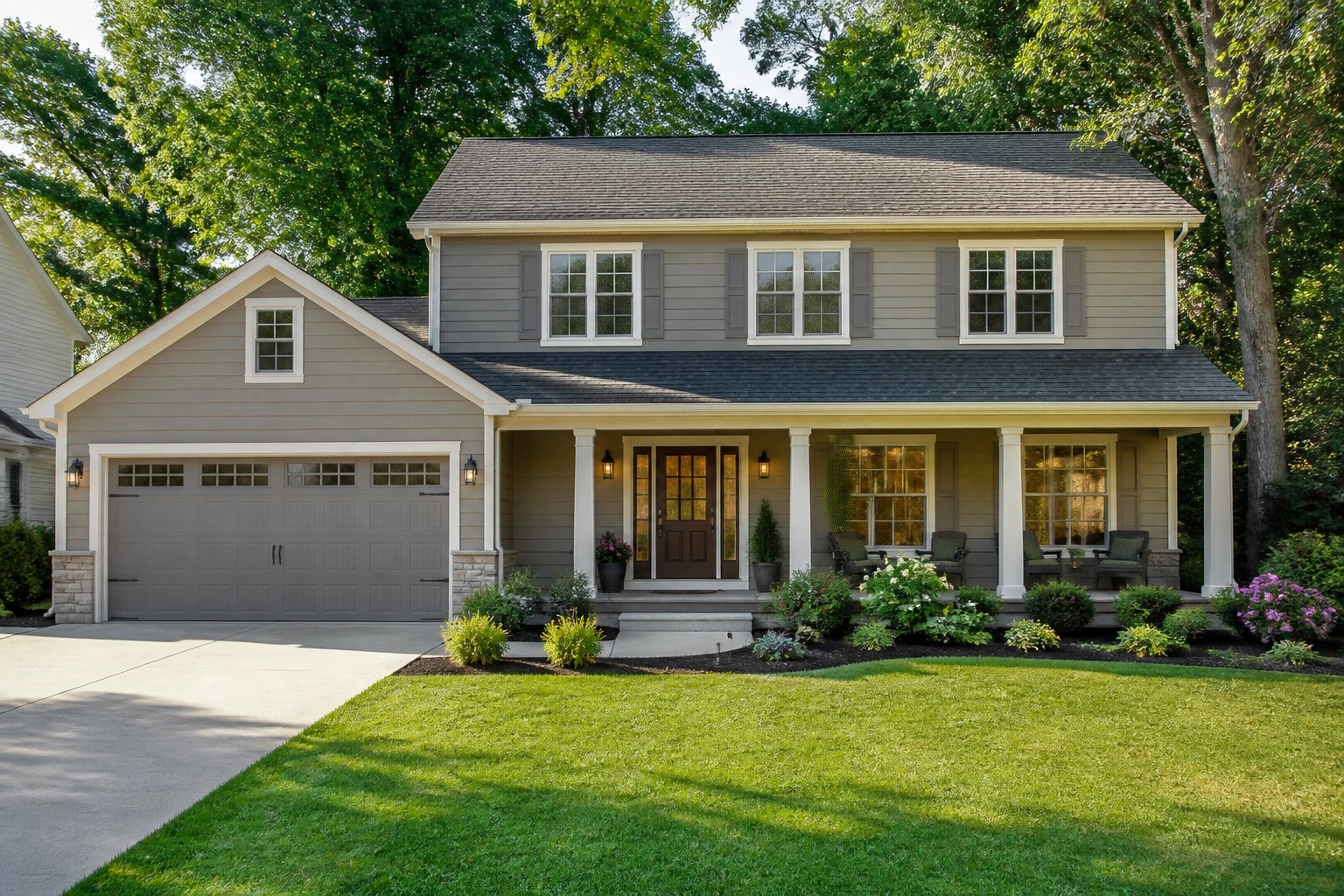A classic American home with a front porch and navy shutters.